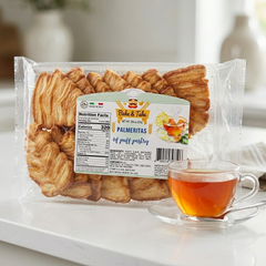 Bake & Take Palmeritas 12-pack Italian puff pastry cookies, golden, flaky, and beautifully layered on a white plate.