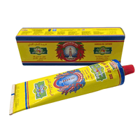 Authentic Harissa Du Cap Bon Tunisian chili paste in 140g tube, spicy red pepper with garlic and caraway, shown in lifestyle setting.