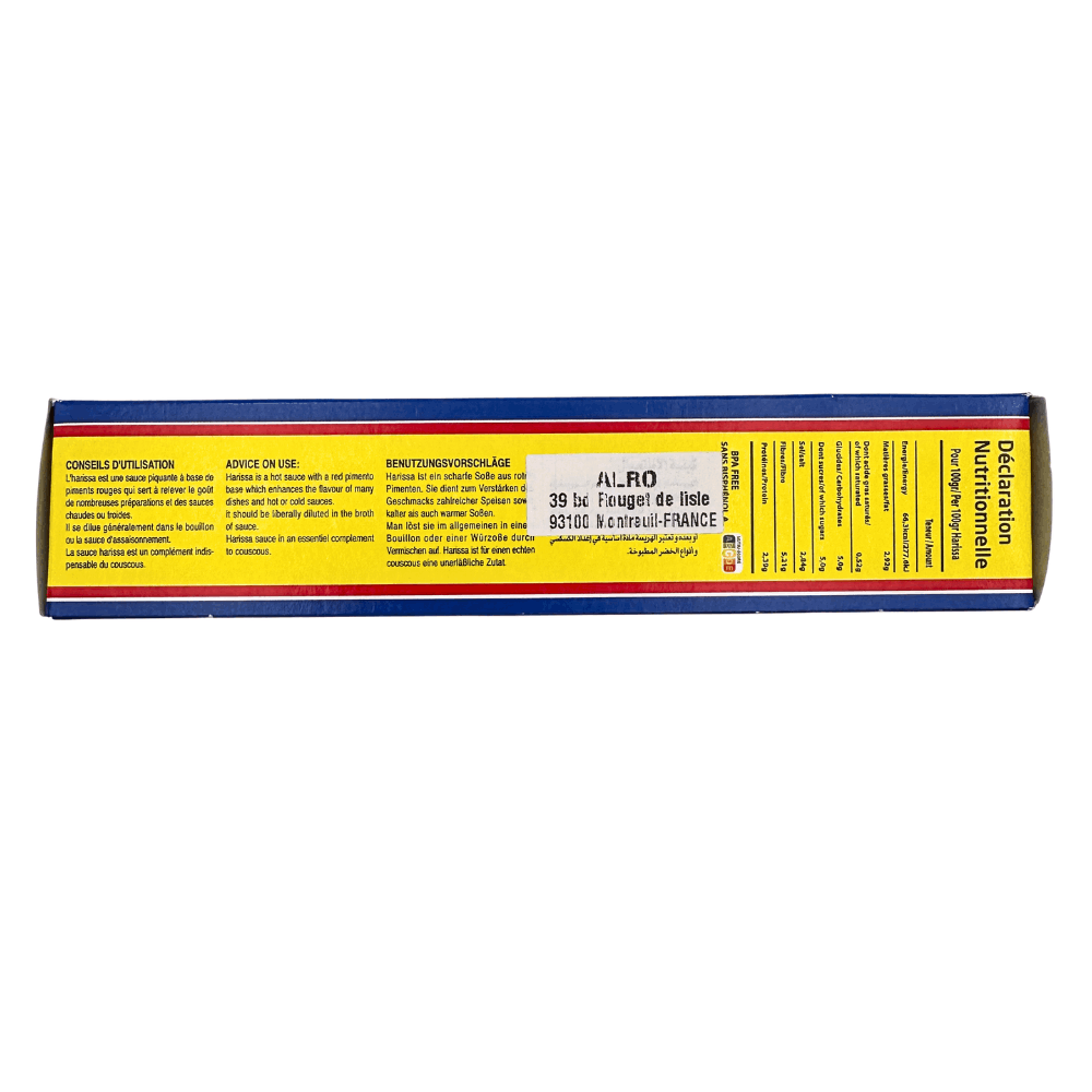 Side view of Harissa brand Tunisian Harissa chili paste in a 140g tube, featuring red pepper, garlic, and caraway ingredients.